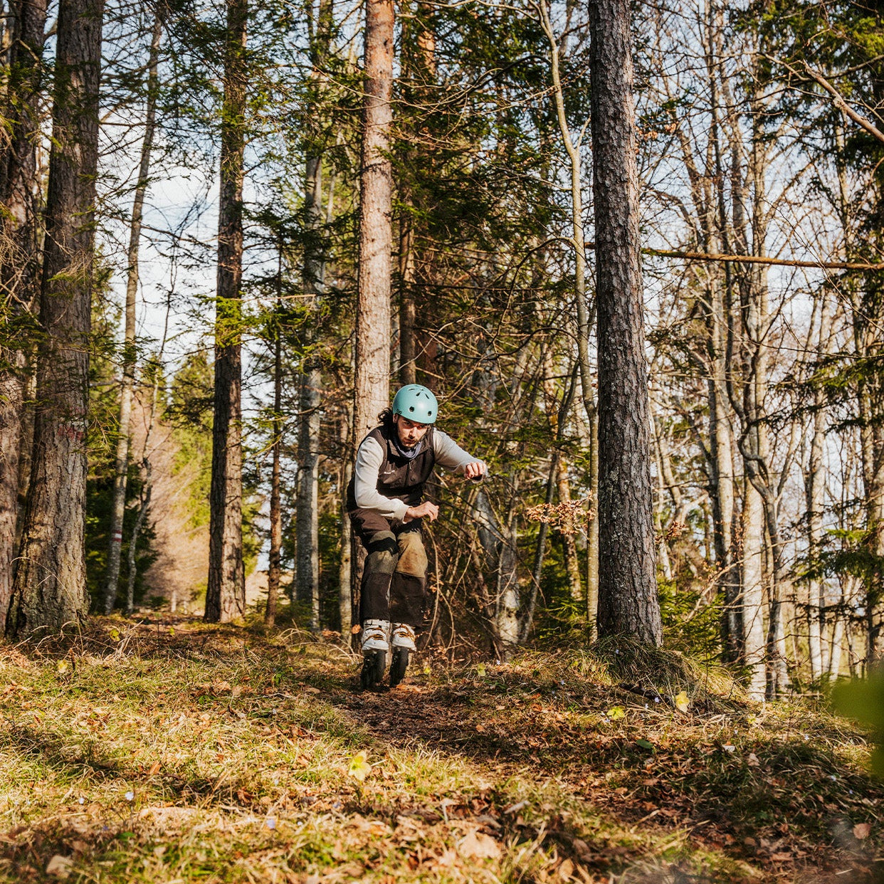 Person skating with FlyingEagle TERRA FRAMES through a forest
