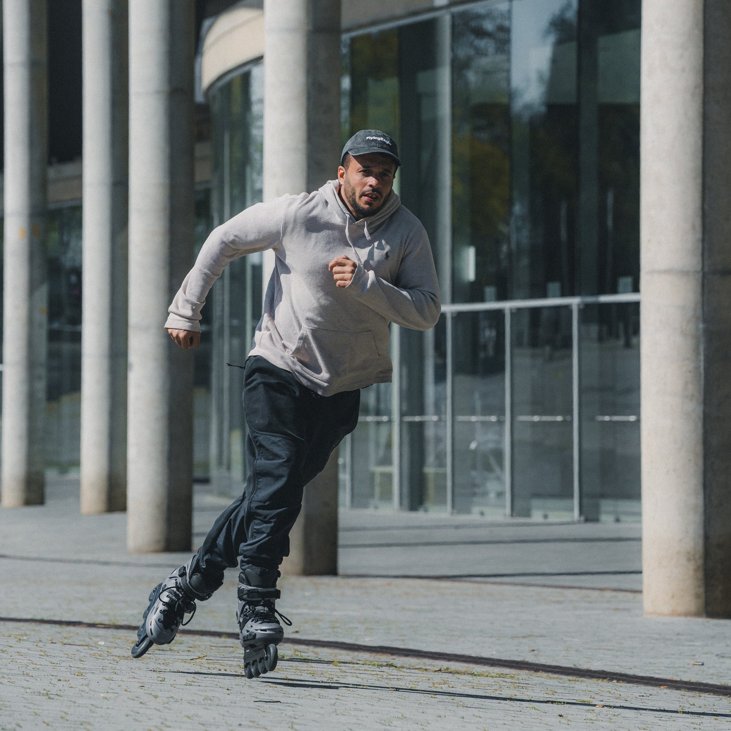 Urban skater speeding on pavement with FlyingEagle FALCON Pro titanium 20-year edition skate