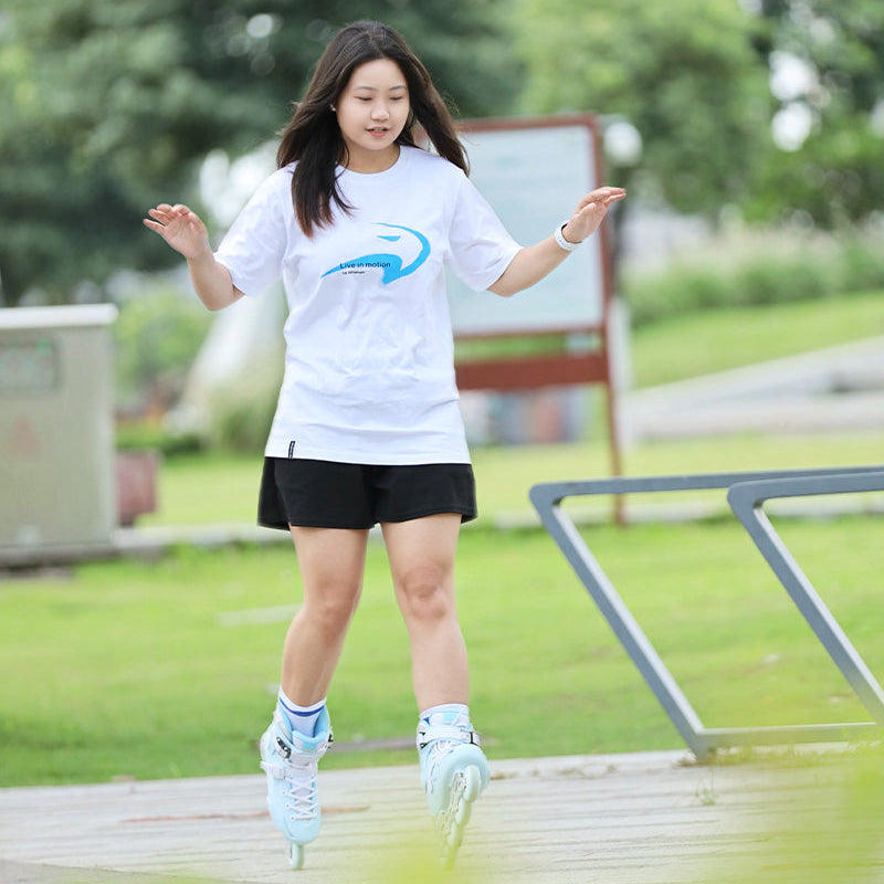 Casual sport look skater in white sprayed cotton t-shirt doing daily roller skating sports