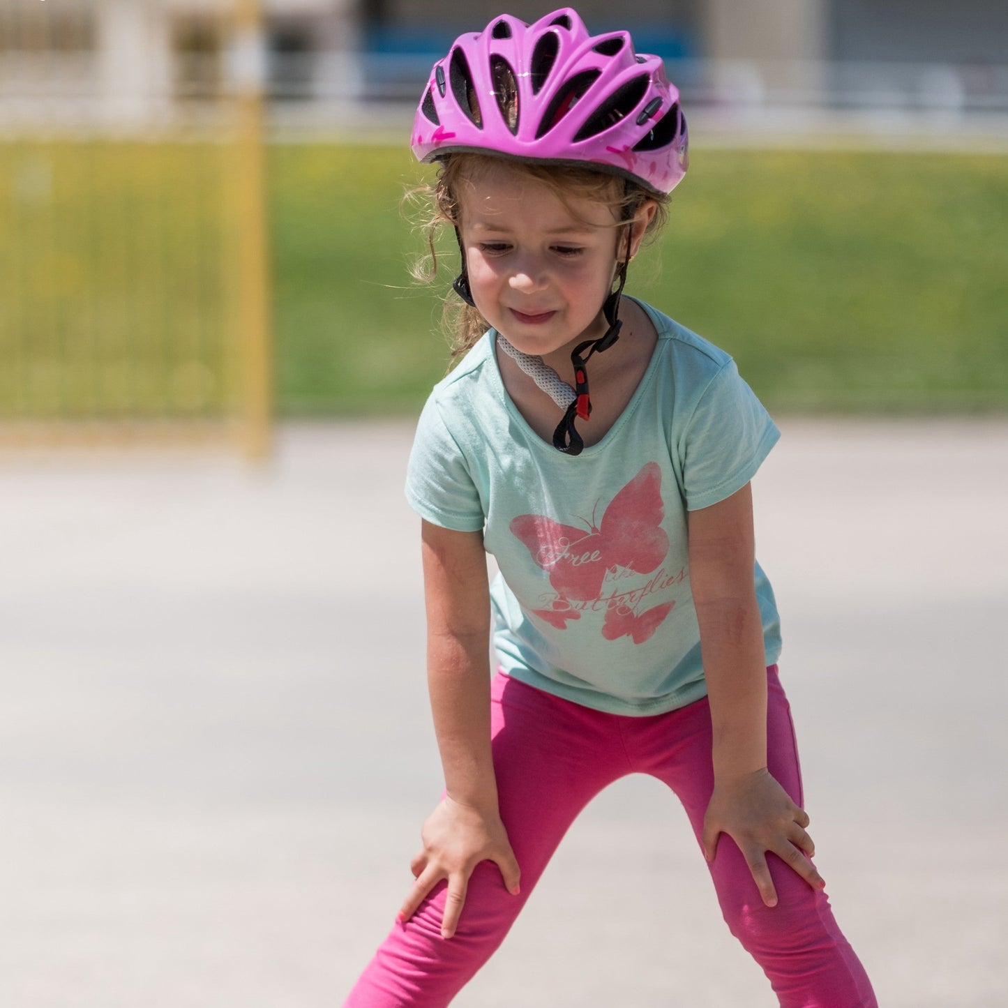 Kid wearing FlyingEagle RAPIDO JR helmet while practicing roller skating outdoors