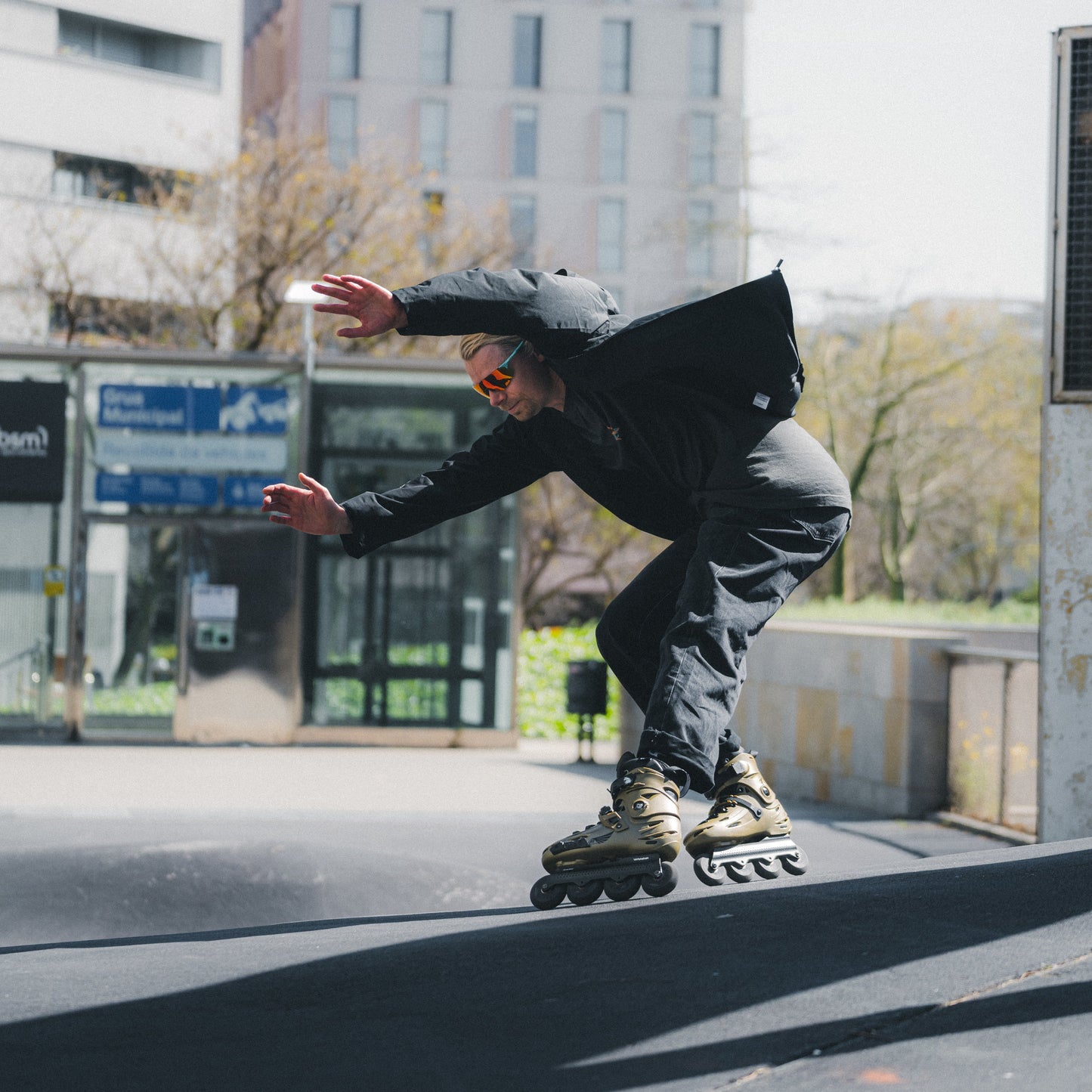 Skater performing urban skating tricks with FlyingEagle FALCON Pro gold 20th edition skates