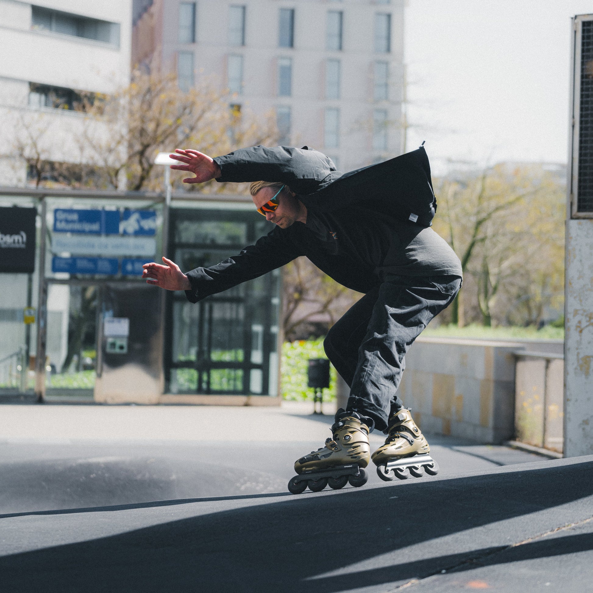 Skater performing urban skating tricks with FlyingEagle FALCON Pro gold 20th edition skates