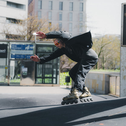 Skater performing urban skating tricks with FlyingEagle FALCON Pro gold 20th edition skates