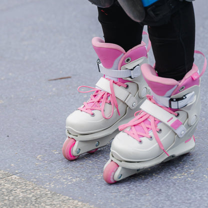 Child wearing FlyingEagle VIREO white and pink roller skates with pink laces for skating.