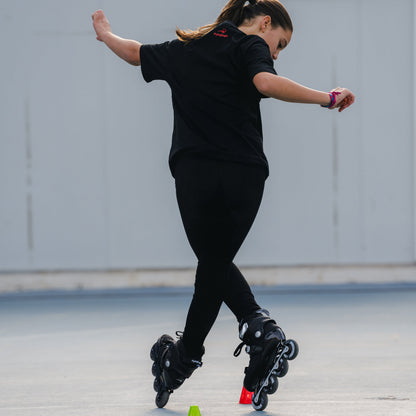 Child doing professional slalom moves in lightweight carbon kids skates