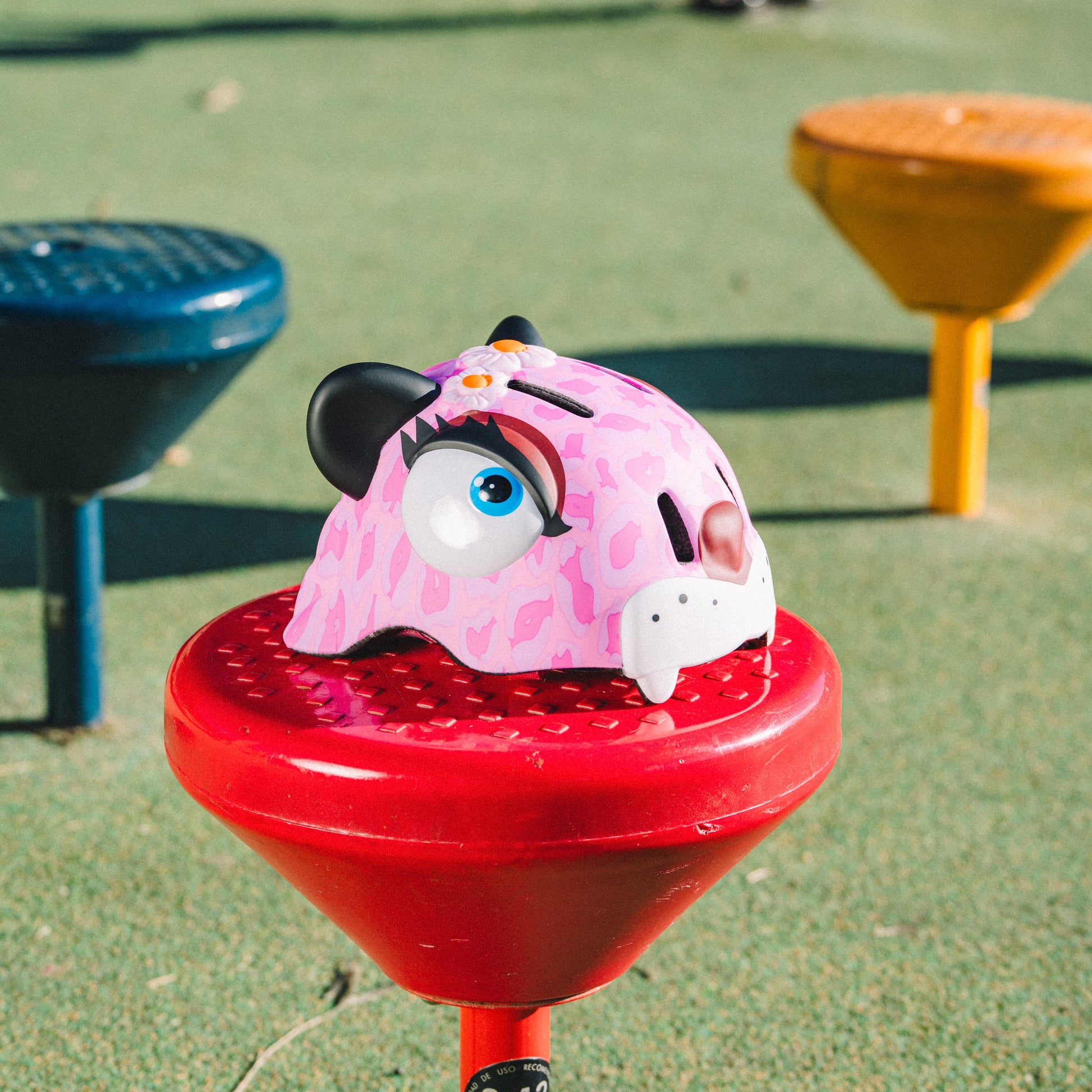 FlyingEagle KT pink leopard helmet placed on outdoor kids sports ground