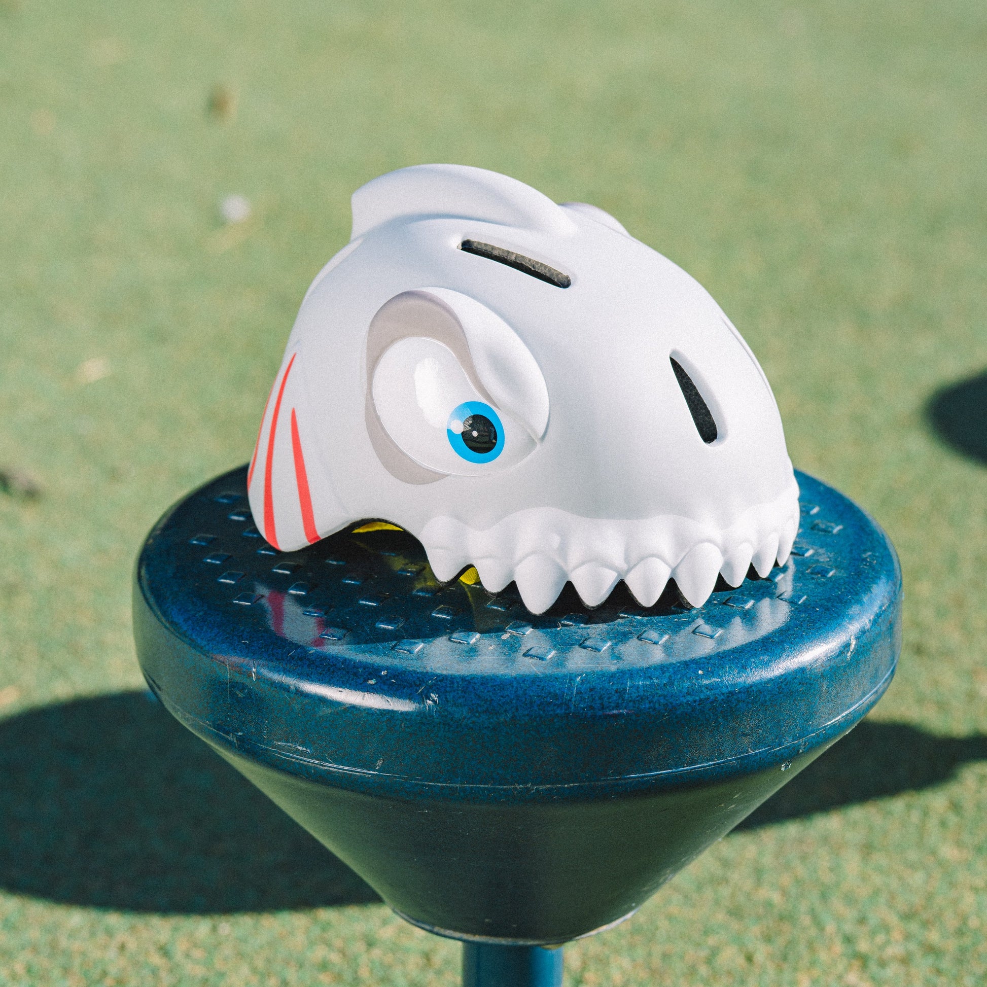 FlyingEagle KT grey shark helmet laid on playground outdoor ground