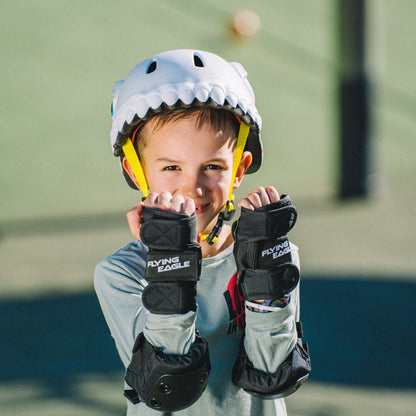 Little kid wearing FlyingEagle KT grey shark helmet roller skating at park