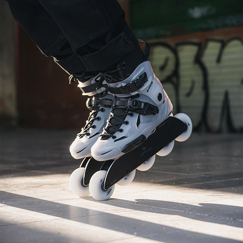 Adult skater riding FlyingEagle SHRIKE Pro R5 inline skates in urban outdoor street
