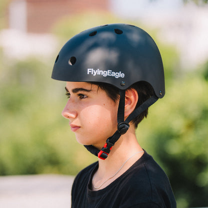 Model wearing Flying Eagle URBAN black skate helmet, adjustable retention ring secure comfortable fit for urban skating protection