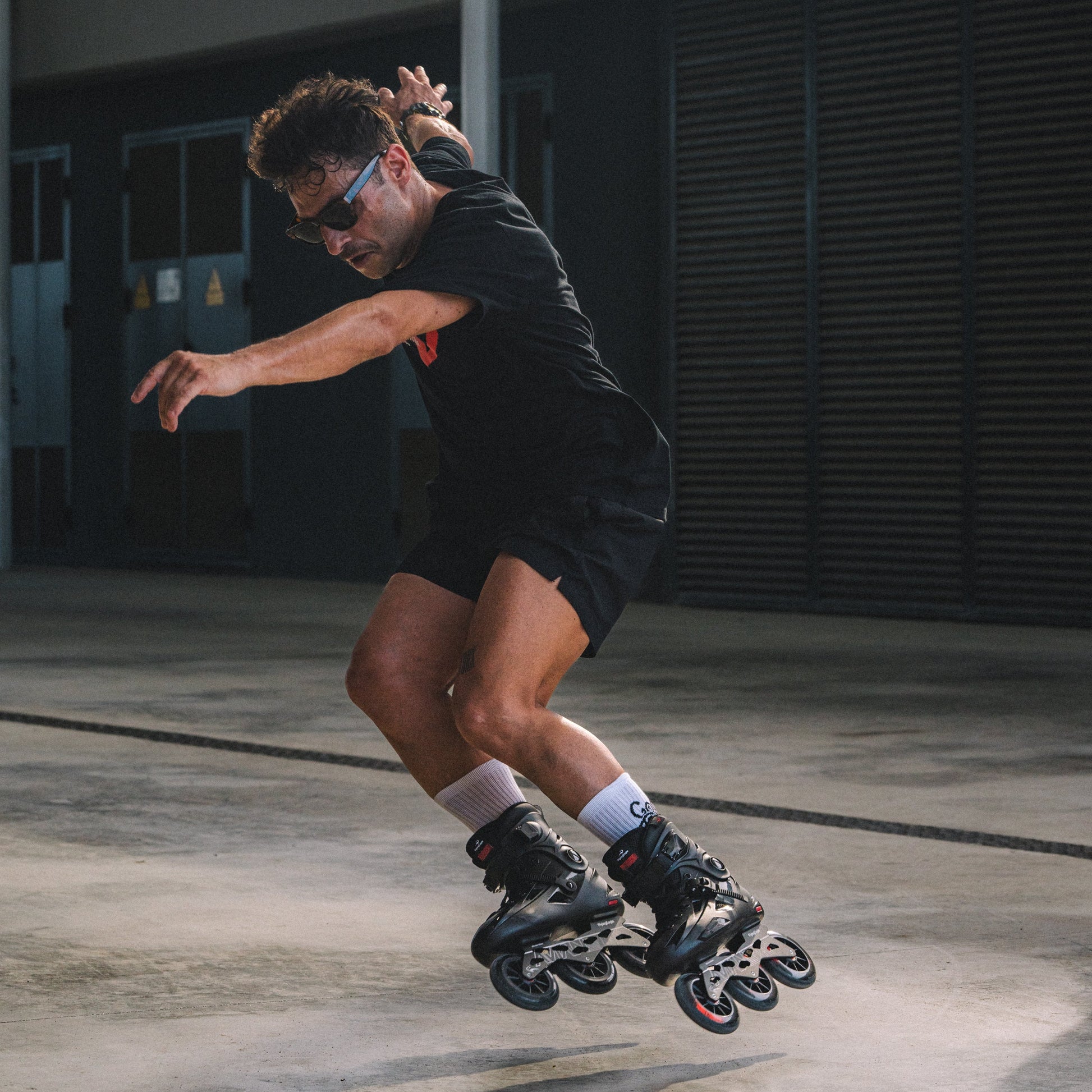 Skater riding 3x110mm wheel inline skates FlyingEagle AVIAN T110 in urban area