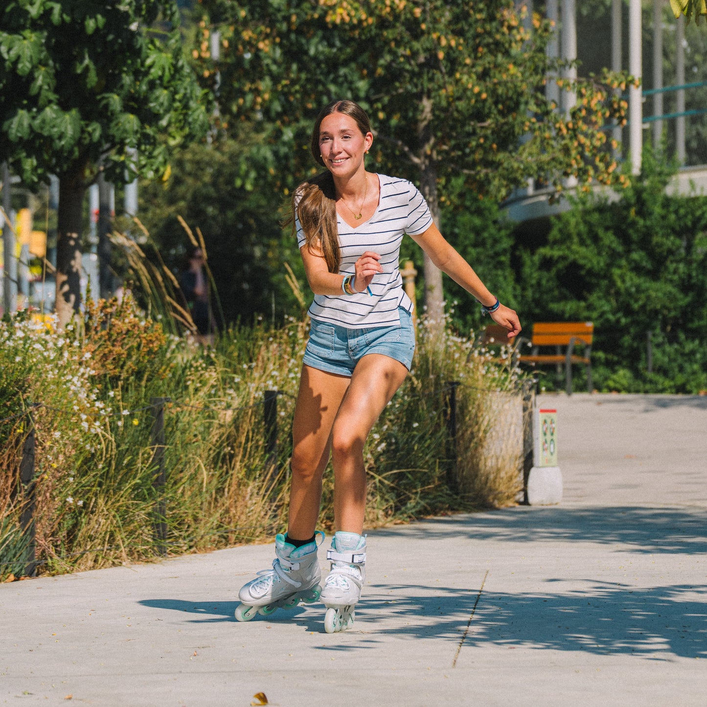 Rider sliding flat urban road with Flying Eagle SHRIKE mint 4-wheel hard boot inline skates for daily fitness skating