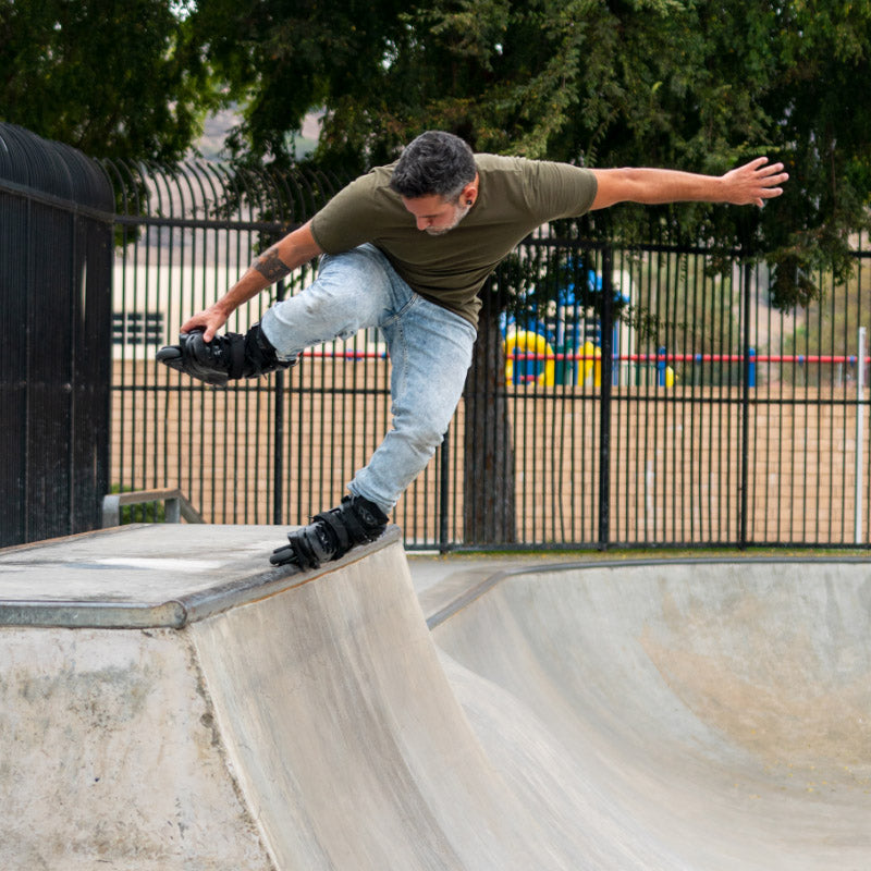 Person skating on a concrete bowl at a skate park with FlyingEagle ENKIDU inline skates
