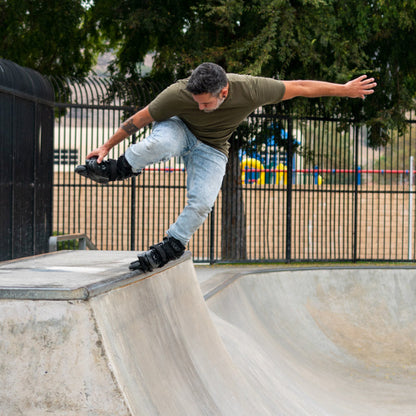 Person skating on a concrete bowl at a skate park with FlyingEagle ENKIDU inline skates