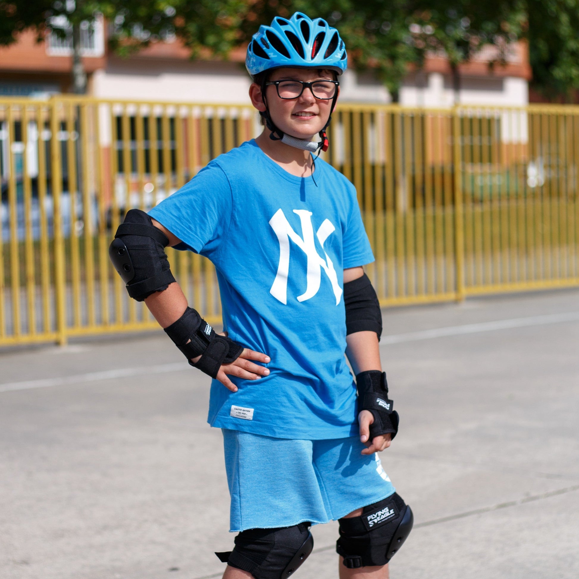 Child with FlyingEagle RAPIDO JR helmet riding balance bike on playground