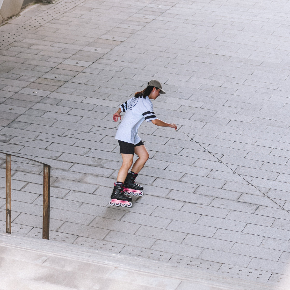 A person wearing Flying Eagle REAVER S7680 ROSE adult inline skates, urban fitness 4‑wheel 85A skates rockerable axles`