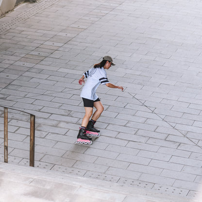 A person wearing Flying Eagle REAVER S7680 ROSE adult inline skates, urban fitness 4‑wheel 85A skates rockerable axles`