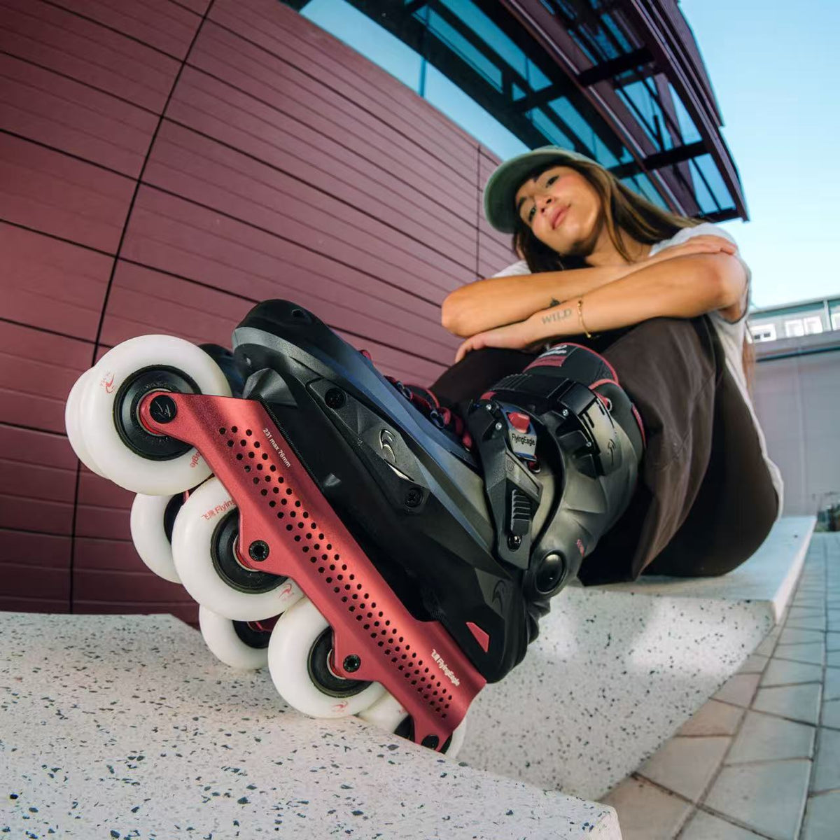 A person wearing Flying Eagle REAVER S7680 ROSE adult inline skates, urban fitness 4‑wheel 85A skates rockerable axles