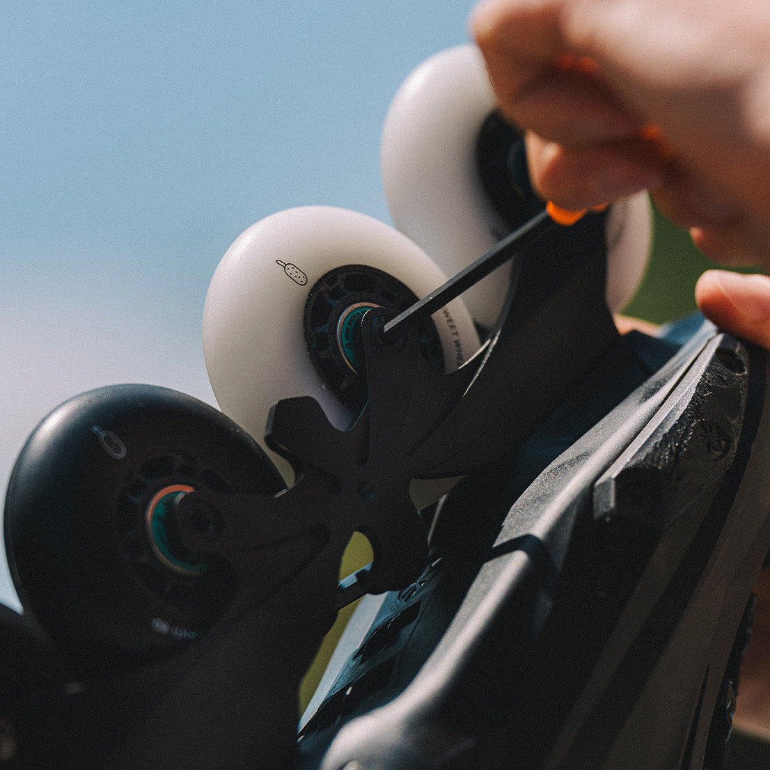 Person adjusting inline skate wheels with Flying Eagle Sweet Wheels CROCANTI ICE CREAM