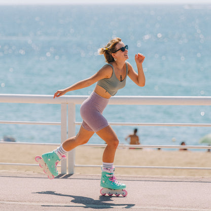 Skater gliding smoothly in teal Flying Eagle SHRIKE Lite urban inline skate