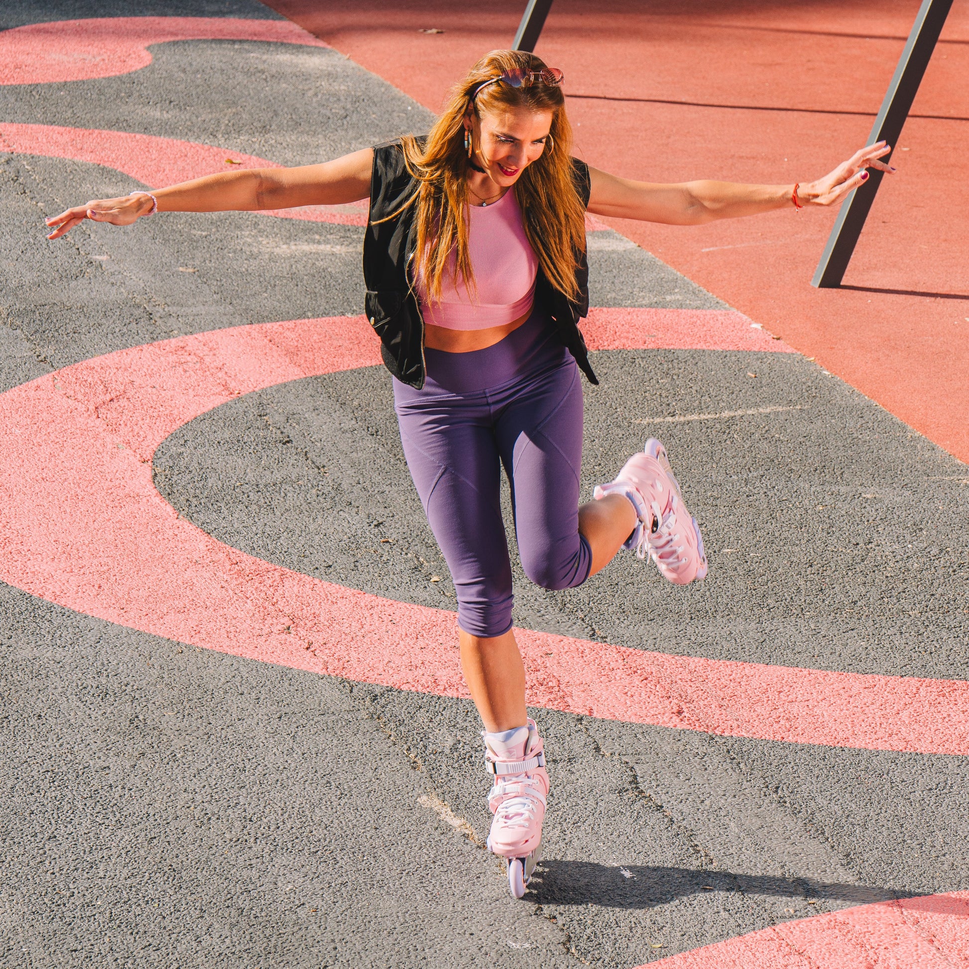 Woman in athletic wear jumping on a playground surface with Flying Eagle Eclipse inline skate