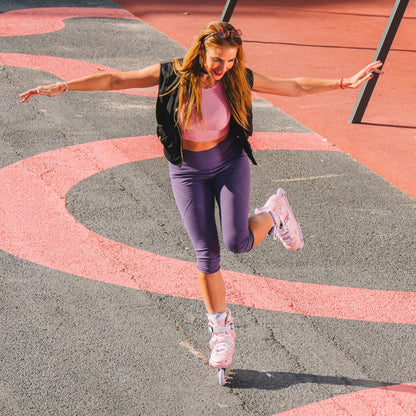 Woman in athletic wear jumping on a playground surface with Flying Eagle Eclipse inline skate