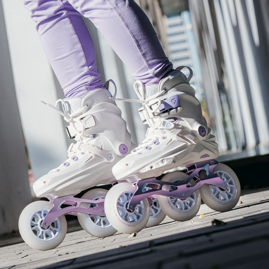 Person wearing white FlyingEagle REAVER TRI with purple accents on a blurred background