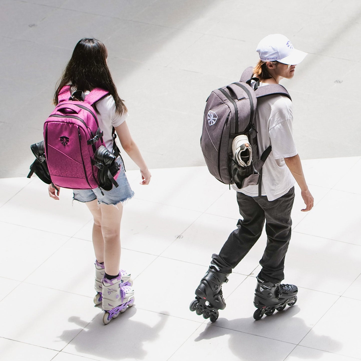 Two skaters with FlyingEagle MOVEMENT backpack skating outdoors