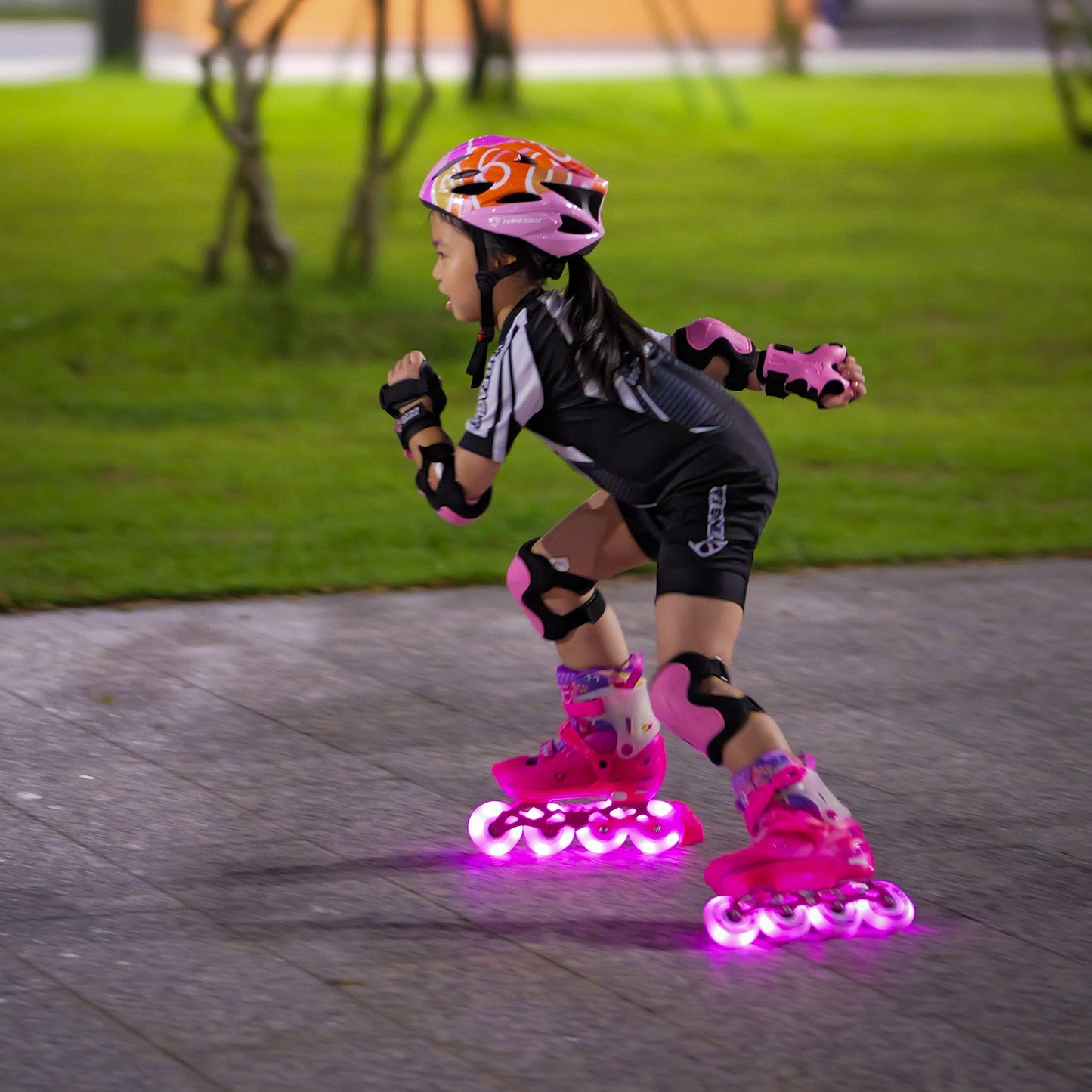 Kid gliding in urban park with FlyingEagle LUMAFLY LED wheel inline skates