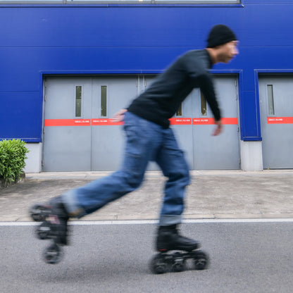 Skater  gliding urban street on Flying Eagle ECLIPSE TRI black 110mm 3‑wheel adult inline skates