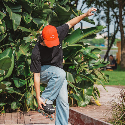 Skater wearing FlyingEagle ICON CAP cotton hat while doing inline skating tricks outdoors