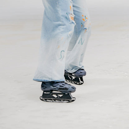Skater gliding on ice with inline skates fitted with FlyingEagle ICE BLADES
