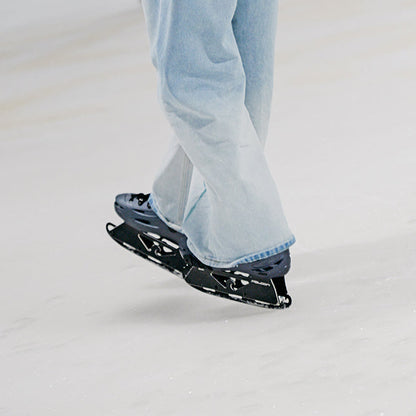 Rider skating at ice rink wearing roller skates equipped with FlyingEagle ICE BLADES