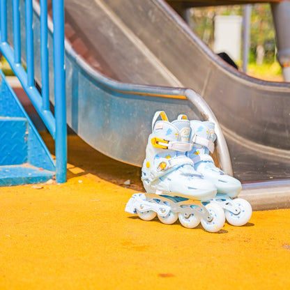 FlyingEagle S7 PRO NIMBUS blue kids inline skates with white wheels on a playground surface.