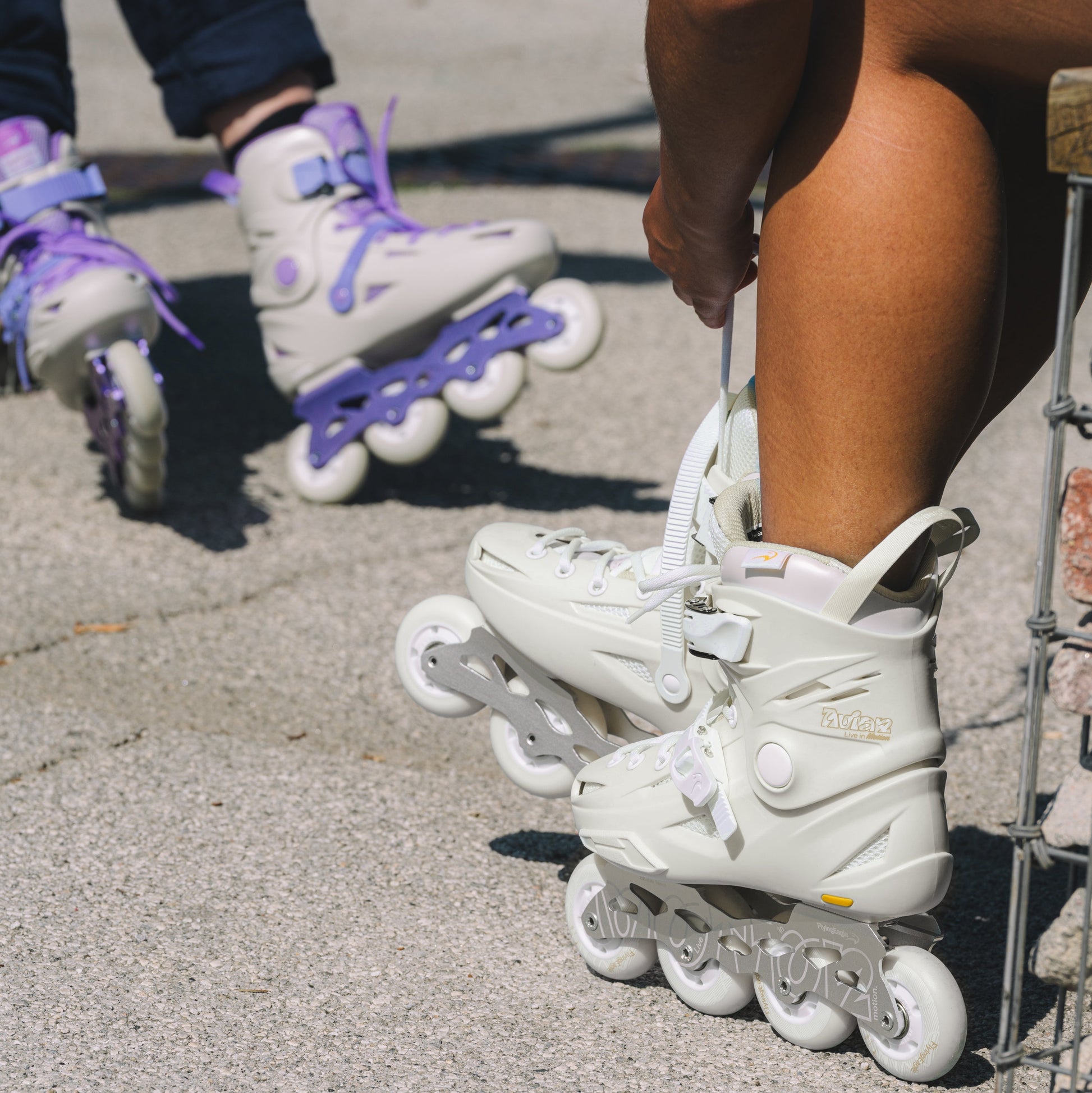 Flying Eagle AVIAN beige adult inline skates placed outdoors, 4-wheel hard boot setup for urban flat ground fitness skating