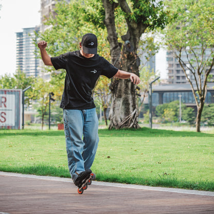 Skater wearing FlyingEagle black ICON TSHIRT performing outdoor inline skating moves