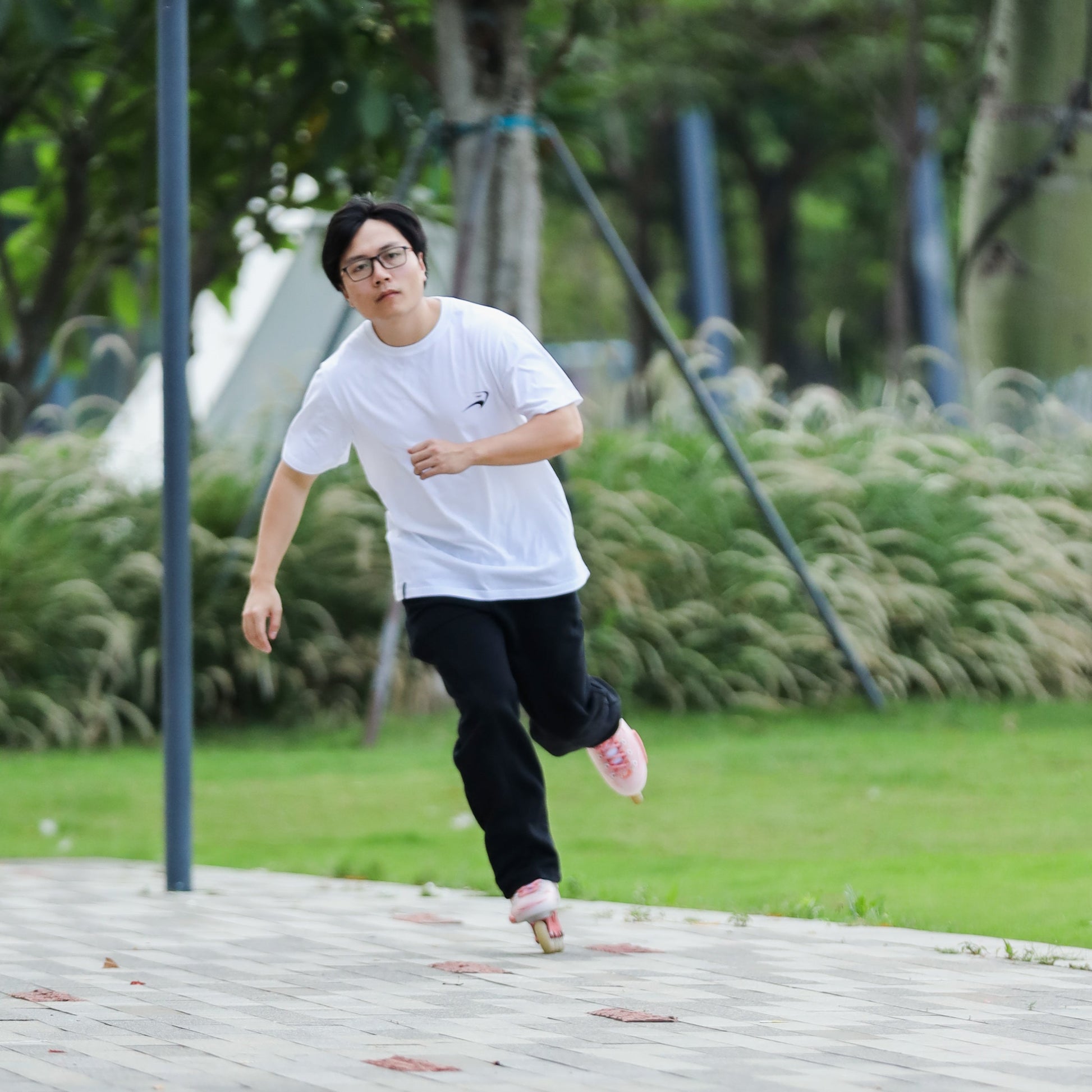 Casual sport look skater in white pure cotton icon tee enjoying daily inline skating