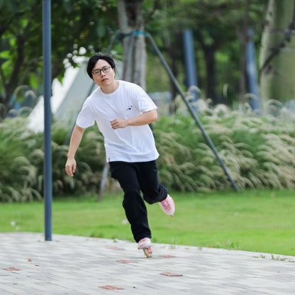 Casual sport look skater in white pure cotton icon tee enjoying daily inline skating