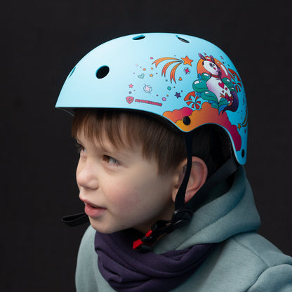Young child with FlyingEagle RIDER JR blue helmet practicing skateboarding outdoors