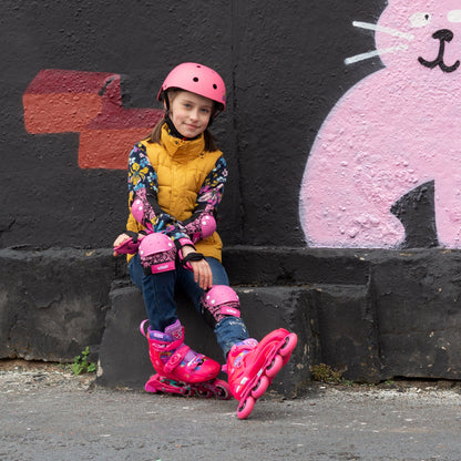 Little girl gliding smoothly outdoors in pink FlyingEagle SPROUT inline skates