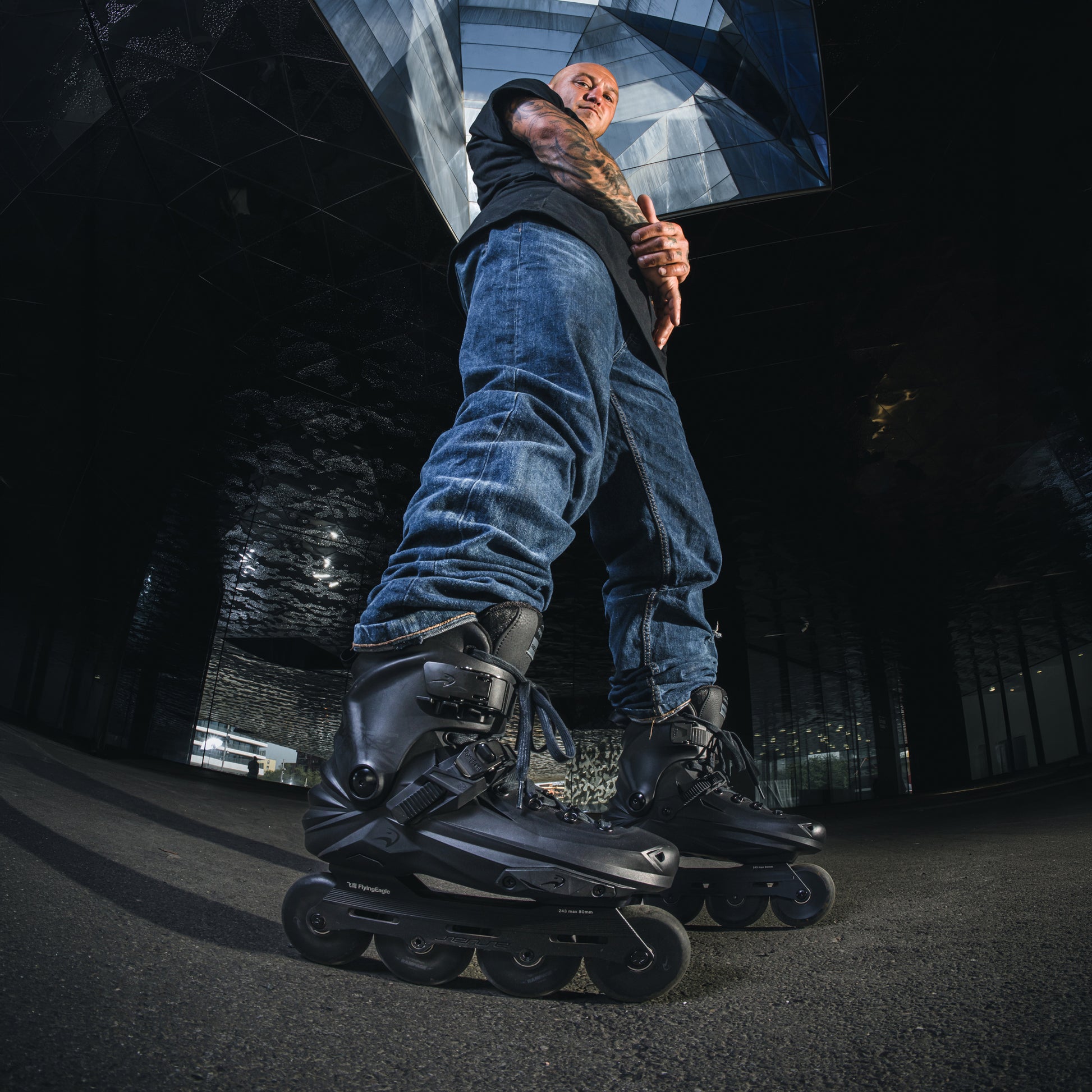 Adult wearing black freestyle skates FlyingEagle REAVER Pro S7680 with SHR 88A wheels